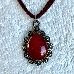 Dark red gemstone pendant on fabric rope